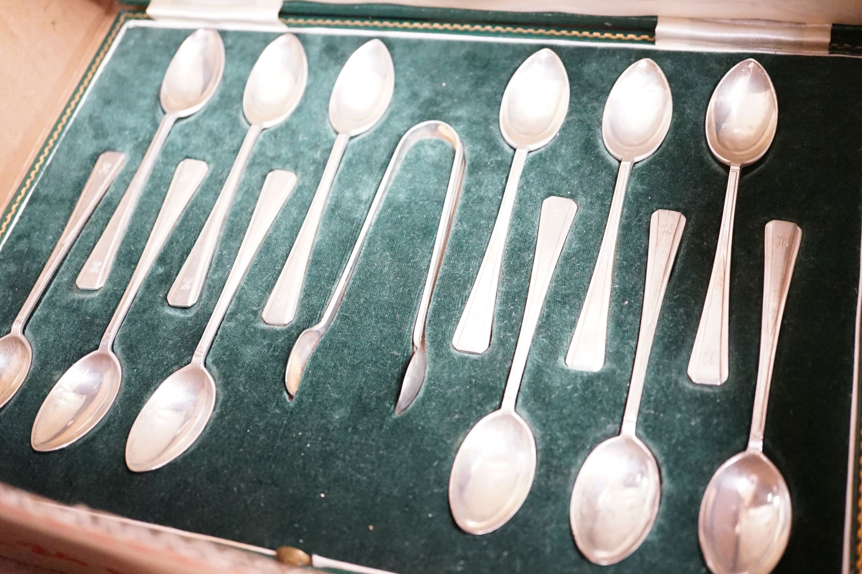 A mixed collection of sundry English silver to include unboxed flatware, a cased set silver teaspoons with tongs, further boxed cutlery including plated a four piece silver and enamel mounted glass dressing table set (en